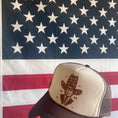 Load image into Gallery viewer, Brown and Cream Trucker Hat that has a graphic of Trump wearing a hat that says "Don't be All Hat No Maga 2024" Background of image is American flag.