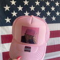 Load image into Gallery viewer, Bubblegum Pink Trucker Hat with an Image of Donald trump when he was younger wearing oink trucker on a vintage phone. The background says 1-800-makw America Great Again Repetitively.