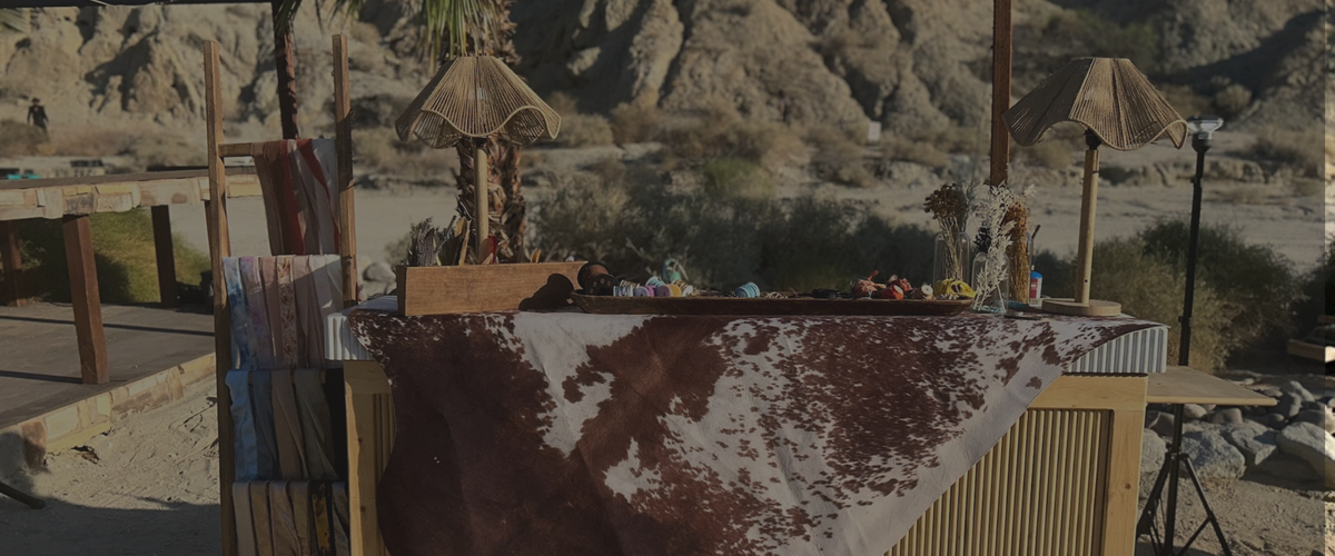 Desert landscape with a bar setup featuring cowhide rug and decorative elements.
